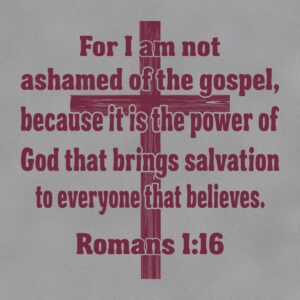 Close up of the Holmes FCA shirt back print: For I am not ashamed of the gospel, Romans 1:16, in maroon over a rustic wooden cross on Sport Grey