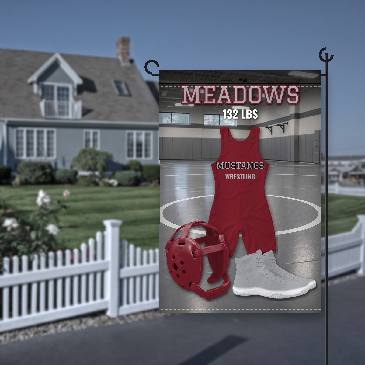 Holmes Mustangs wrestling garden flag in maroon and gray: maroon singlet lettered Mustangs Wrestling in a gray wrestling room, maroon headgear and gray shoes, the name Meadows and 132 LBS at the top, on a stand in front of a house