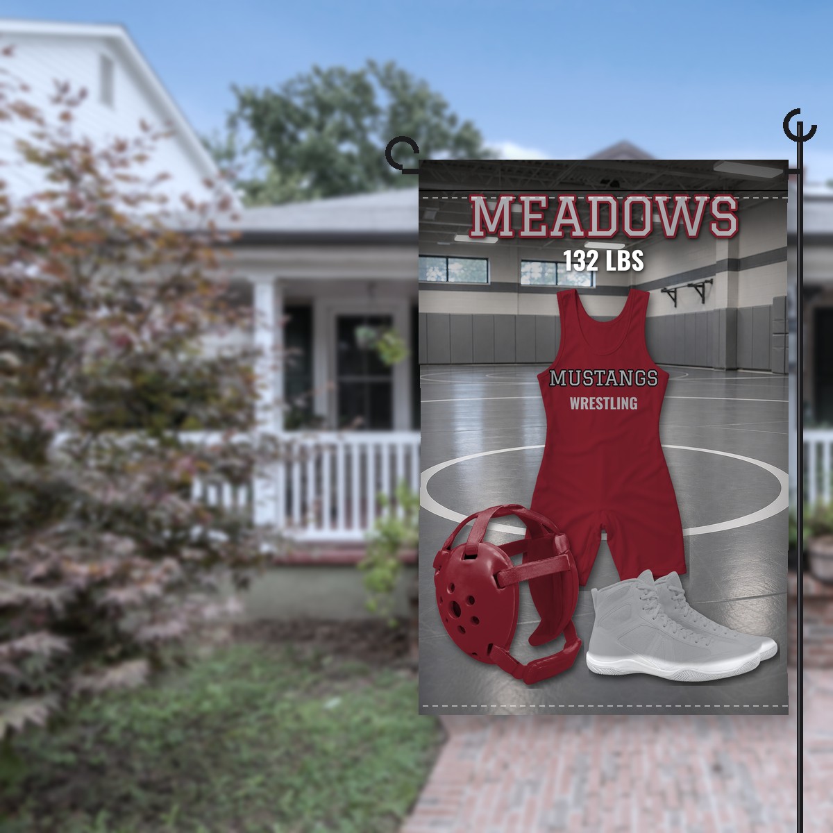 Holmes Mustangs wrestling garden flag in maroon and gray: maroon singlet lettered Mustangs Wrestling in a gray wrestling room, maroon headgear and gray shoes, the name Meadows and 132 LBS at the top, on a stand in front of a house